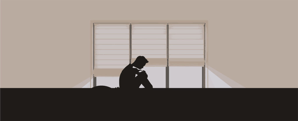 若者が一人でうずくまっている絵