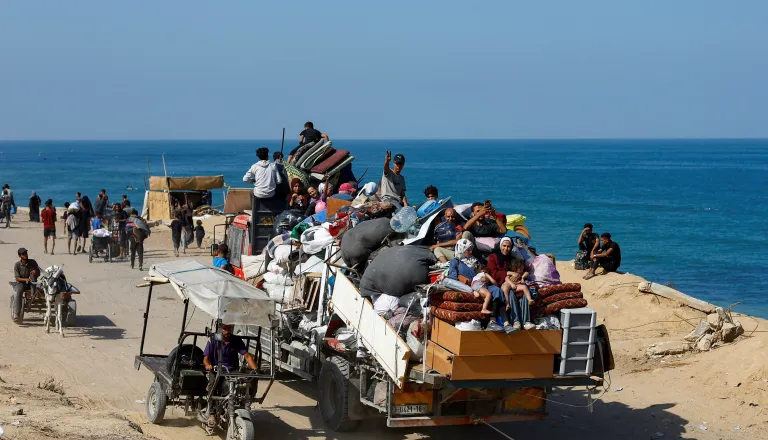several people from Gaza city and thier luggage carried in a carrier