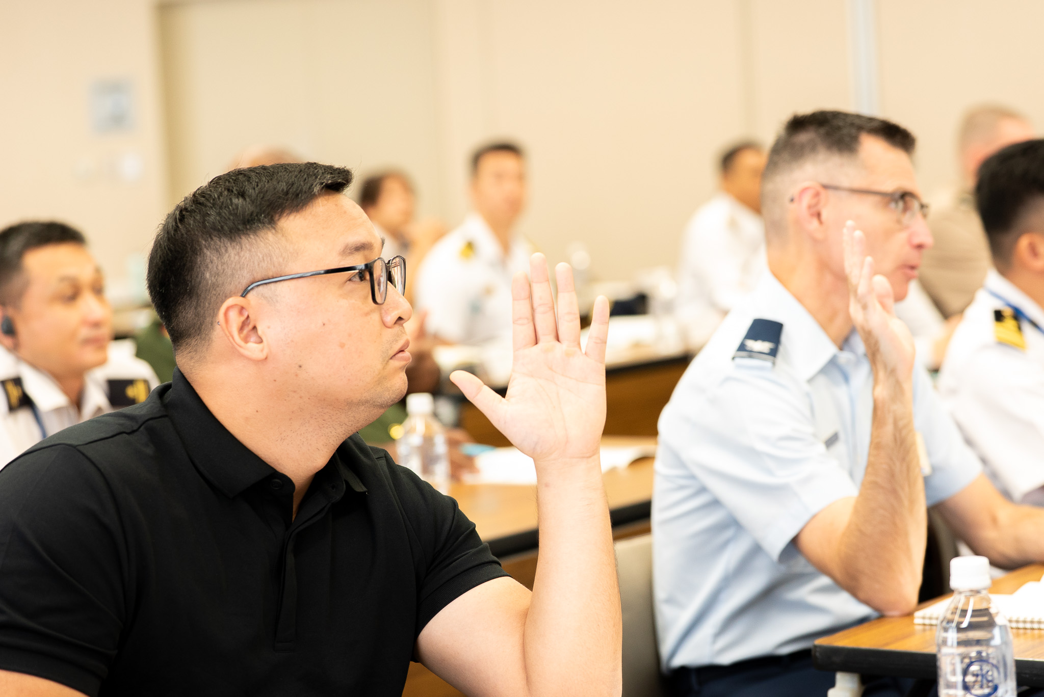 two persons raising their hands during the IHL seminar